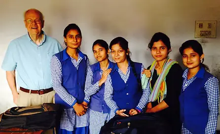 Five college level students posing next to their professor for a picture.